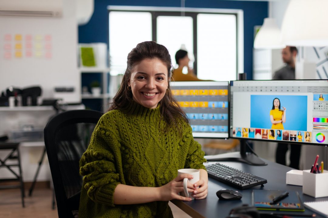 woman-retoucher-looking-at-camera-smiling-working-in-creative-media-agency.jpg